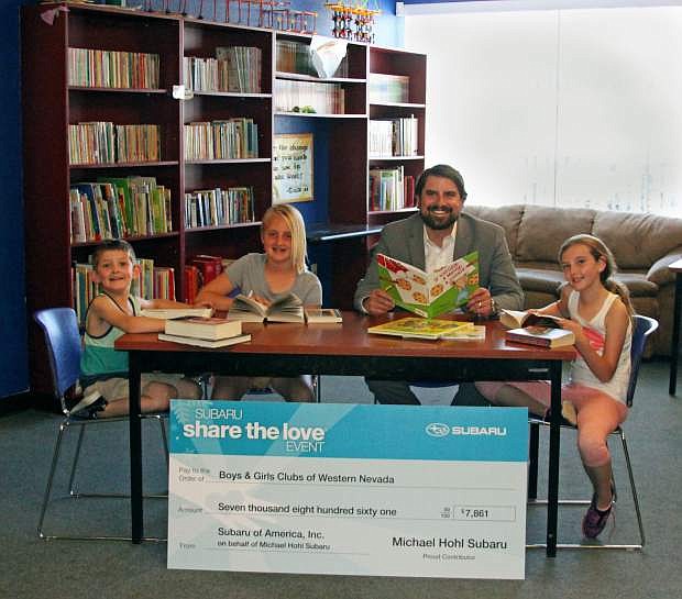 Boys &amp; Girls Clubs of Western Nevada members read along with Matthew Hohl, of Michael Hohl Subaru.