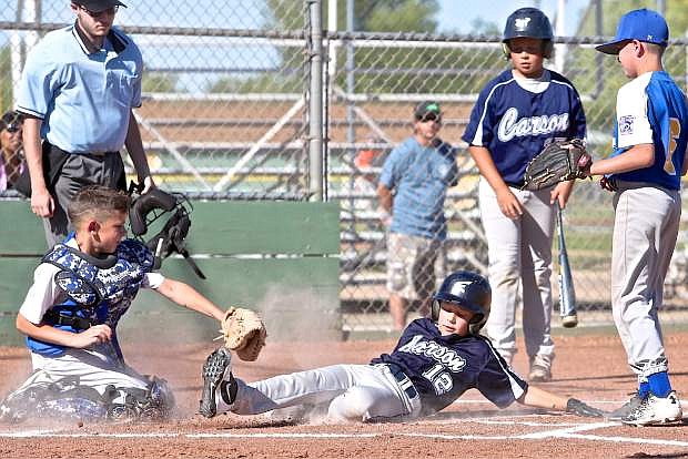 10-year-old Tyler Silsby of the Carson All-Stars slides safely into home Wednesday evening against the South Tahoe All-Stars.