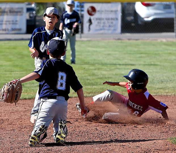 Shortstop Eastyn Hendrix underhands a throw to second baseman Ashton Wilkin in effort to put out a Truckee player Friday evening.