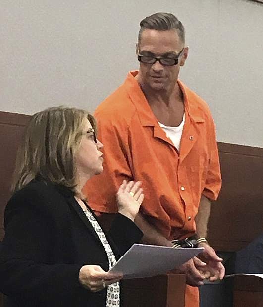 FILE - In this Aug. 17, 2017 file photo, Nevada death row inmate Scott Raymond Dozier confers with Lori Teicher, a federal public defender involved in his case, during an appearance in Clark County District Court in Las Vegas. A judge says the first execution in Nevada in 12 years can go forward next month, after the state Supreme Court rejected a challenge of a never-before-tried combination of drugs for the lethal injection. Dozier&#039;s death warrant, signed Tuesday, June 19, 2018, in Las Vegas, sets an unspecified date the week of July 9 for his execution at the state prison in Ely. (AP Photo/Ken Ritter, File)
