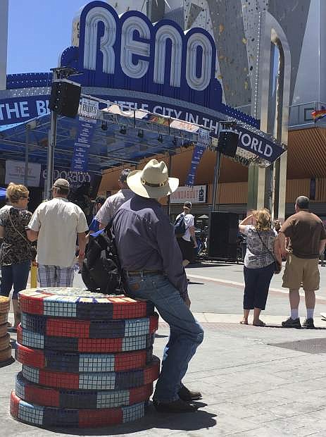 Visitors to the BBQ, Brews and Blues festival listen to a band in downtown Reno on June 16, 2018. The number of tourists visiting Reno-Sparks and Washoe County over the past year topped the 5 million mark for the first time since 2007. (AP Photo/Scott Sonner).