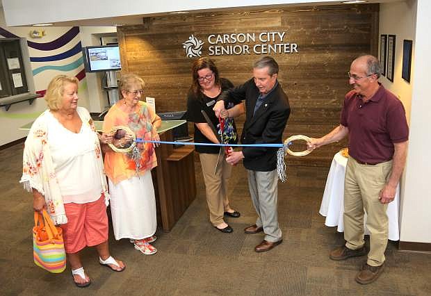 Senior Center Director Courtney Warner and Mayor Bob Crowell cut a ribbon to celebrate the renovation of the new lobby area at the Senior Center on Tuesday. Looking on are, from left, Laurel Stadler, Mary Geisler and Mike Pavlakis.