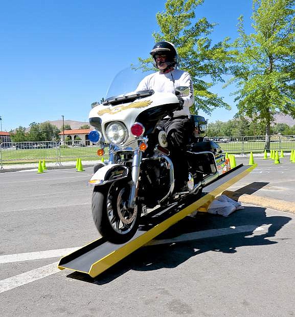 CCSO motor deputy Wayne Wheeler gets his front wheel light as he crosses the teeter-totter Thursday during practice for this weekend&#039;s event in Mills Park.
