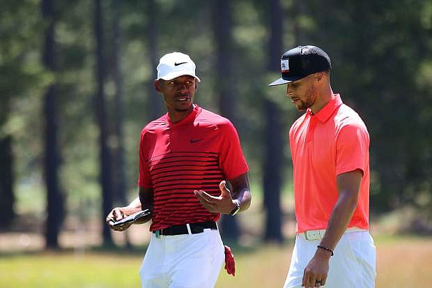 Former NBA guard Ray Allen, left, and Golden State Warriors guard Steph Curry chat on the green of hole No. 9 at the American Century Championship at Edgewood Tahoe on Saturday.