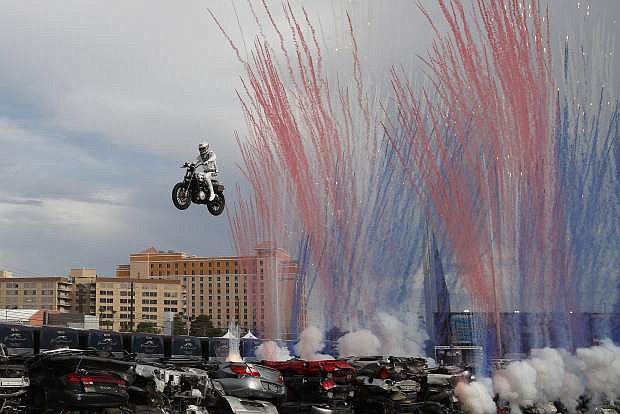 Travis Pastrana jumps a row of crushed cars on a motorcycle, Sunday, July 8, 2018, in Las Vegas. Pastrana is attempting to recreate three of Evel Knievel&#039;s iconic motorcycle jumps on Sunday, including the leap over the fountains of Caesars Palace that left Knievel with multiple fractures and a severe concussion. (AP Photo/John Locher)