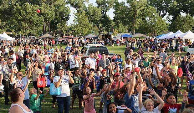 A crowd gathers at a chance to catch a mini-football or tee shirt at the National Night Out event on Tuesday.