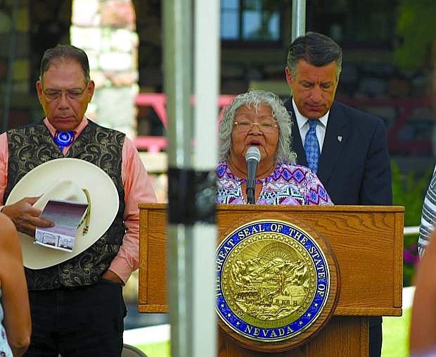 Dinah Pete of the Washoe Tribe of Nevada and California delivers a blessing for the construction of the Stewart Indian School Cultural Center and Museum, which is expected to open in the spring of 2019. Behind her is Nevada Gov. Brian Sandoval. Also pictured is Nevada Indian Commission Chairman Richard Arnold.