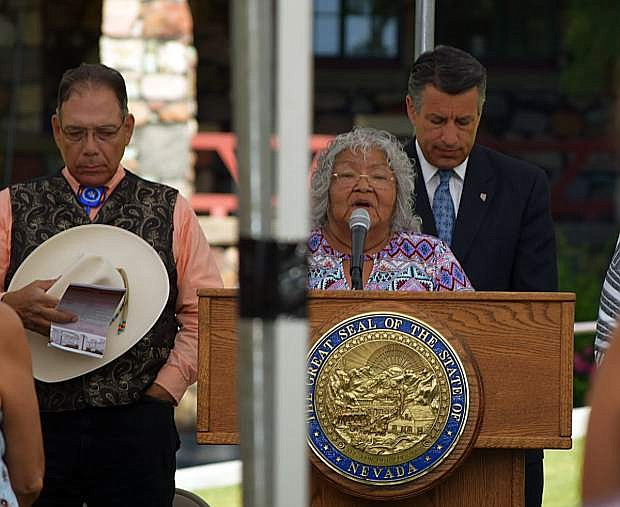 Dinah Pete of the Washoe Tribe of Nevada and California delivers a blessing for the construction of the Stewart Indian School Cultural Center and Museum, which is expected to open in the spring of 2019. Behind her is Nevada Gov. Brian Sandoval. Also pictured is Nevada Indian Commission Chairman Richard Arnold.