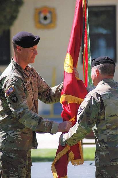 Lt. Col. Dustin G. Bishop, left, incoming commander, accepts the guidon from Col. James L. Brown. Heidi Bunch / MCIN