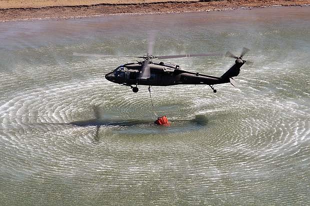 A Nevada Army Guard UH-60 Black Hawk fills its 660-gallon water bucket during training at Stampede Reservoir, Calif., in June 2015.