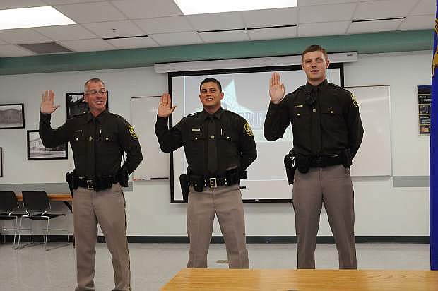 Daniel Regalado, center, was sworn in as a full time deputy and Todd Sampson, left, and Jacob Tavcar, right, were sworn in as reserve officers.