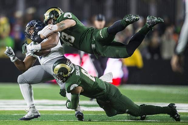 Colorado State linebacker Evan Colorito, top, and safety Jake Schlager tackle Nevada running back Kelton Moore last season. Since scrimmages don&#039;t count, Nevada needs to beat Portland State.