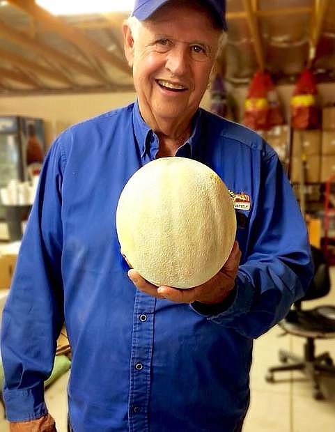Rick Lattin, seen here holding a cantaloupe grown on his farm, has been part of the festival since its inception in 1985.