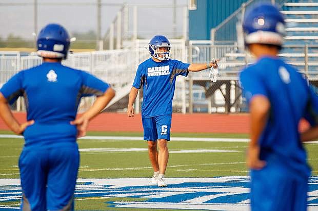 Chance Smith pumps up the team at the start of the season opening football practice at Carson High School.