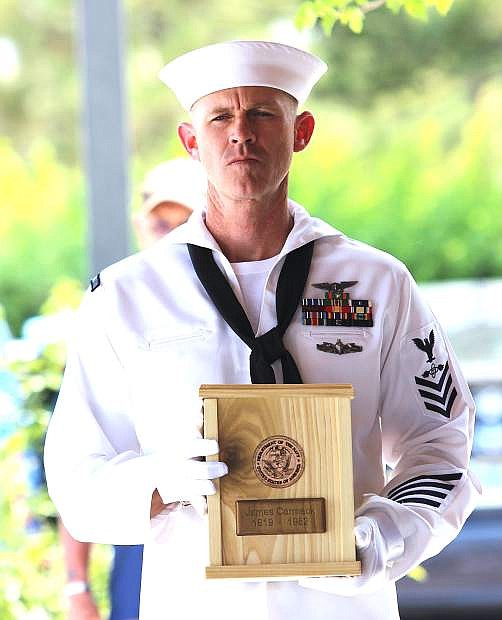 AT1 Karl Stone of Naval Air Station Fallon carries one of 16 urns.
