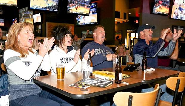Carson City residents Lori Echeverria, Deb and Brent Olson and Vince Echeverria cheer for the Nevada Wolf Pack basketball team at Buffalo Wild Wings as they battle Loyola-Chicago last season.