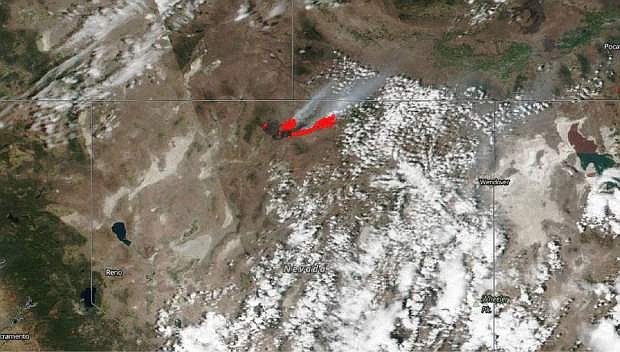 FILE - This July 8, 2018 satellite file image from NASA&#039;s Suomi NPP satellite shows a wildfire, shown in red, also known as the Martin Fire, in Nevada, and smoke reaching to Idaho. Destruction of sage grouse habitat by a series of large wildfires has prompted a ban on hunting for the game bird this fall across a stretch of north-central Nevada nearly twice as big as the state of Delaware. The Nevada Board of Wildlife Commissioners approved the emergency closure Friday, Aug. 17, 2018, of two specific hunting units in Humboldt and Elko Counties. The Nevada Department of Wildlife says at least 39 known breeding sites supporting about 750 male sage grouse were destroyed in July by the Martin Fire. (NASA via AP, File)