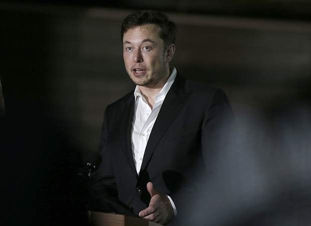 FILE- In this June 14, 2018, file photo Tesla CEO and founder of the Boring Company Elon Musk speaks at a news conference in Chicago. Musk says he&#039;s in talks with the Saudi Arabian sovereign wealth fund about taking the electric car and solar panel maker private, but no deal has been finalized. Musk says in a blog posted Monday, Aug. 13, that most of the funding would be in stock rather than debt. (AP Photo/Kiichiro Sato, File)