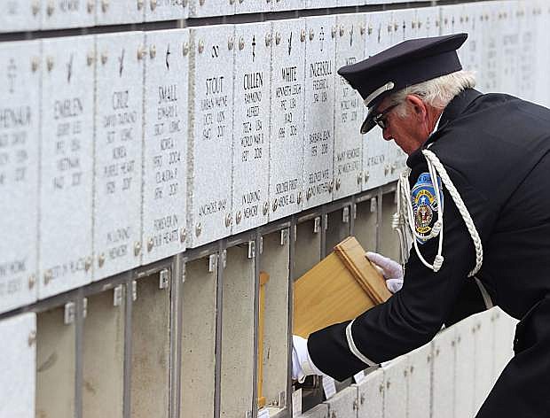 A member of the Nevada Veterans Coalition slides an urn into the columbarium at the Northern Nevada Veterans Memorial Cemetery during a previous mission in May.