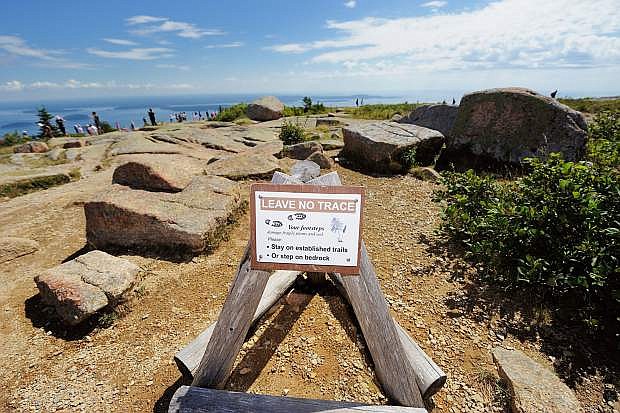 A sign says &quot;Leave No Trace&quot; on top of Cadillac Mountain in Acadia National Park in Maine.