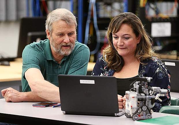 Instructor Dave Riske talks with Sandra Flores a Computer Information Technology class at Western Nevada College in Carson City, on Tuesday, Sept. 27, 2017.
