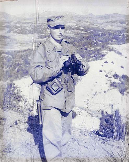 1st Lt. Joseph R. Gutheinz stand at his post with Communist Chinese controlled hills in the background.