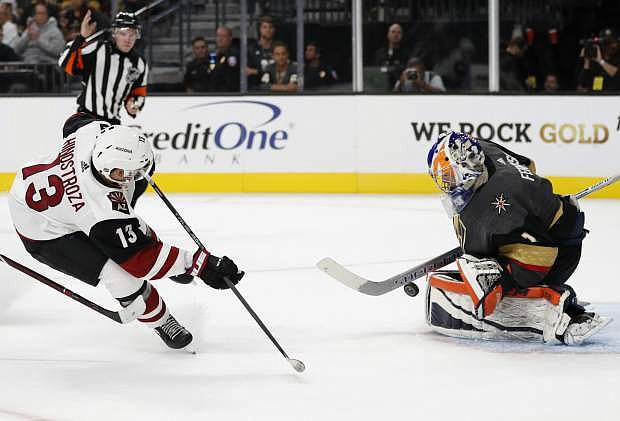 Arizona Coyotes center Vinnie Hinostroza attempts a shot on Vegas Golden Knights goalie Dylan Ferguson during the first period of an NHL hockey game Sunday, Sept. 16, 2018, in Las Vegas. (AP Photo/John Locher)