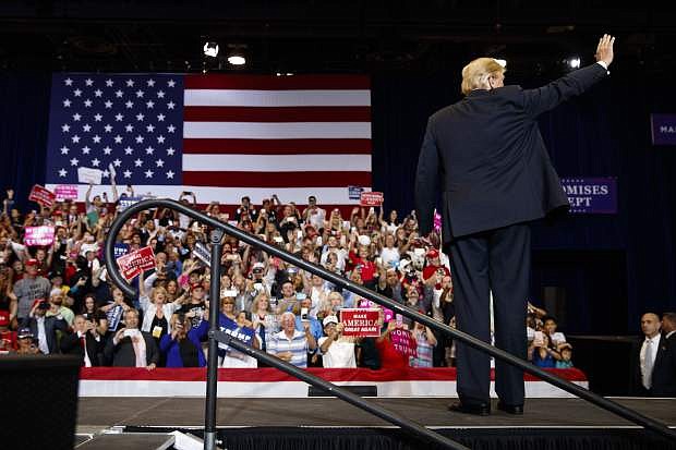 President Donald Trump waves as he arrives for a campaign rally, Thursday, Sept. 20, 2018, in Las Vegas. (AP Photo/Evan Vucci)