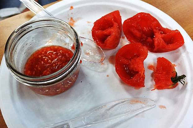 Seeds removed from tomatoes and placed in a jar to use in a future year.