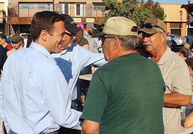 Governor candidate Adam Laxalt, left, talks to residents at the Kiwanis Labor Day pancake breakfast.