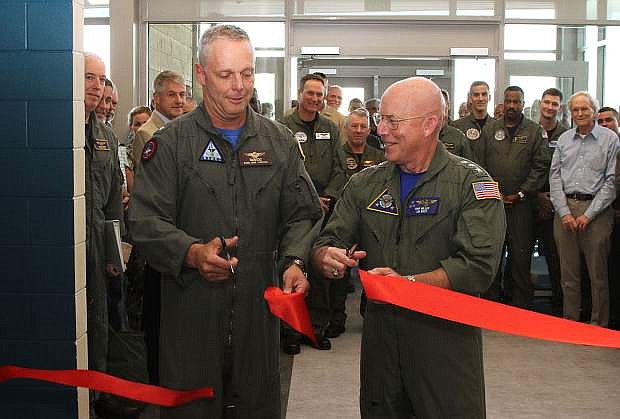 Rear Adm. Dan Cheever, left, commander, Naval Aviation Warfighting Development Center, and Vice Adm. DeWolfe Miller, III commander, Naval Air Forces/Commander, Naval Air Force, US Pacific Fleet, cut the ribbon for a new Air Wing Training building.