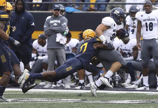 Toledo&#039;s Kahlil Robinson tackles Nevada&#039;s Quinton Conway during the second half of Saturday&#039;s game in Toledo, Ohio.