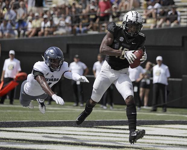 Vanderbilt wide receiver Kalija Lipscomb (16) catches a 2-yard touchdown pass ahead of Nevada defensive back EJ Muhammad (4) in the first half of an NCAA college football game Saturday, Sept. 8, 2018, in Nashville, Tenn. (AP Photo/Mark Humphrey)