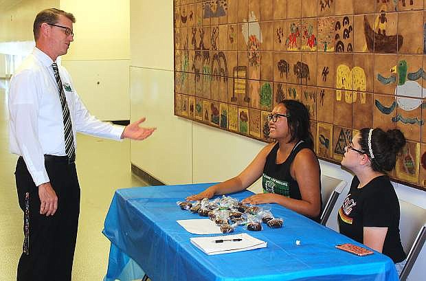 CCHS Principal Scott Winter talks with students Sofia Natividad, left, and Hanna Stewart.