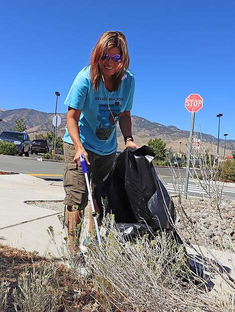 Deana Davis of Gardnerville cleans up trash on REALTORS Give Back Day.