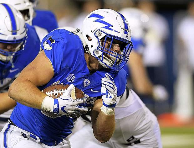 Air Force fullback Cole Fagan carries the ball for a touchdown against Utah State on Saturday in Logan, Utah.