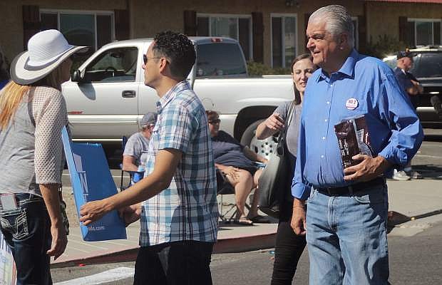 Democratic gubernatorial candidate Steve Sisolak, right, hands out candy in the annual Fallon Lions Club Labor Day Parade.
