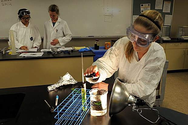 Danielle Osborn works in a biology class at Western Nevada College in Minden, while professor Dr. Elizabeth Tattersall talks with David Gomez in the background. Biology is among the open short-term classes WNC is offering throughout the fall semester.