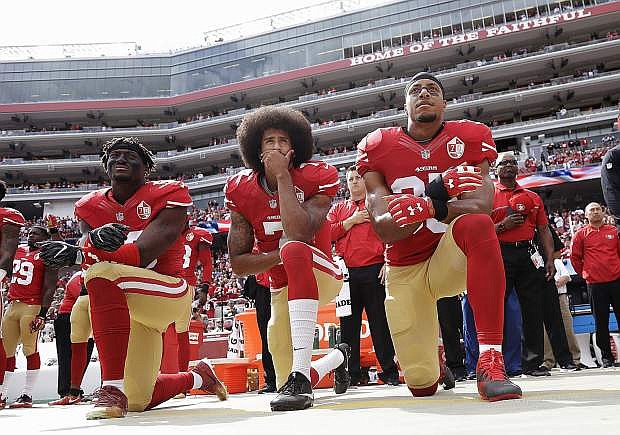 San Francisco 49ers outside linebacker Eli Harold, quarterback Colin Kaepernick and safety Eric Reid kneel during the national anthem on Oct. 2, 2016.