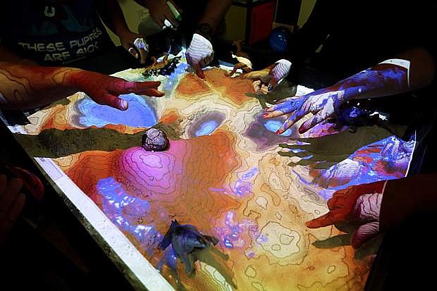 Students and college officials experience the augmented-reality sandbox at Western Nevada College, in Carson City, Nev., on Friday, Sept. 14, 2018. Photo by Cathleen Allison/Nevada Momentum