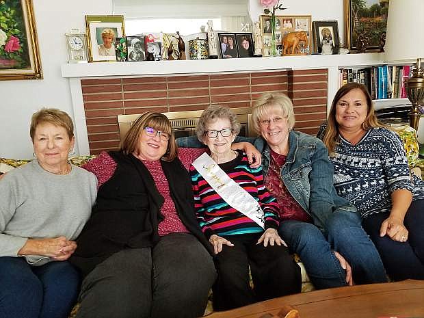 Martha Berger, in the center wearing a sash made for her upcoming birthday party, enjoys a visit with relatives. From left to right, Nina Barry, niece; and Jan Leonard, Dawn Berger, and Lisa Yenter, all grand nieces.