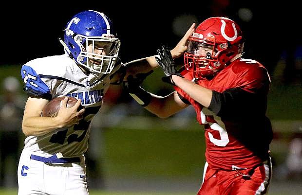 Carson&#039;s Jonathan Laplante stiff arms a Wooster defender during Friday night&#039;s game.