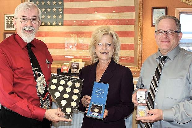 Michael Flanagan, Dorothy Tisdel and Mike Johnson show off the famous Morgan Silver Dollars minted in at the U.S. Mint in Carson City. They are employed at Northern Nevada Coin, 601 N. Carson Street, located right across the street from the Nevada State Museum which houses the former mint. Northern Nevada Coin has a large collection of uncirculated and circulated cc marked coins.