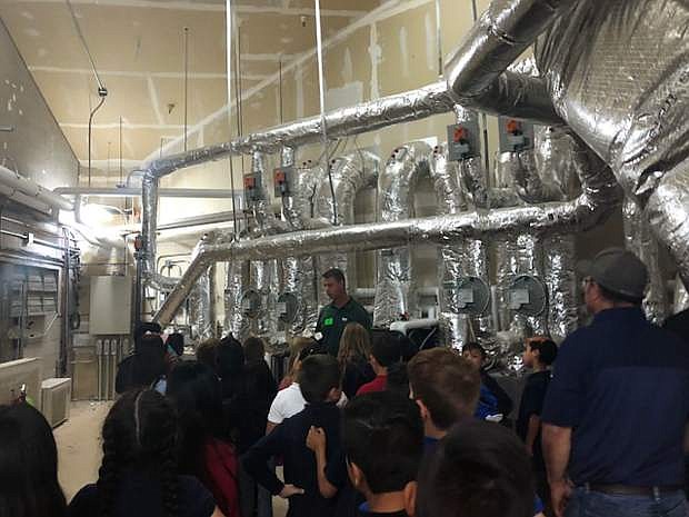 Students at Mark Twain Elementary School tour the bowels of the HVAC (heating, ventilation, and air conditioning) system at their school as they learn about energy efficiency and how they can maximize conservation efforts.