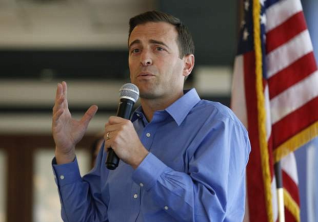 File - In this Aug. 28, 2018 file photo, Nevada state Attorney General Adam Laxalt speaks at the Southern Hills Republican Women&#039;s Club in Henderson, Nev. The Republican gubernatorial candidate said Saturday, Sept. 29, 2018, he was a &quot;reckless and foolish&quot; teen when he was arrested for assaulting a police officer more than 20 years ago in Virginia. Records obtained by the Reno Gazette Journal from the city of Alexandria show the Nevada attorney general was taken into custody for underage drinking in 1996. (AP Photo/John Locher, File)