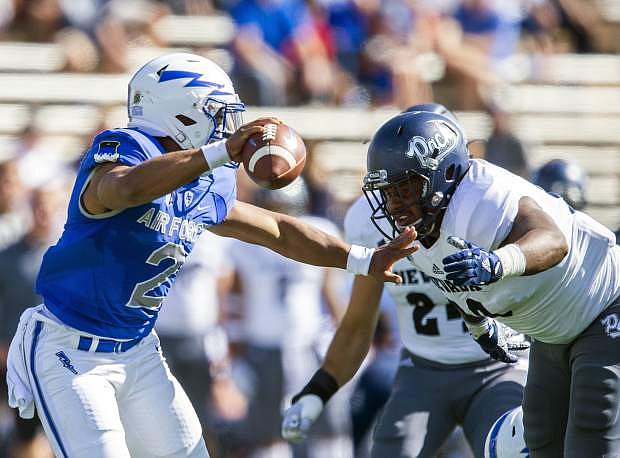 Air Force quarterback Arion Worthman (2) is sacked by Nevada linebacker Malik Reed (90) during the first half of Saturday&#039;s game in Colorado Springs, Colo.