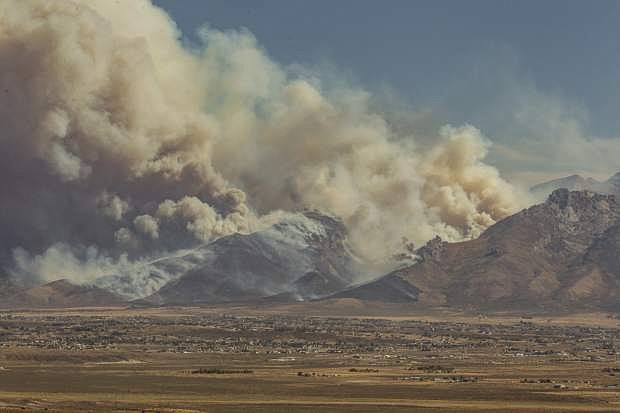 Smoke billows from a wildfire Sunday that briefly trapped eight hikers and a sheriff&#039;s deputy at the top of the Lamoille Canyon about 12 miles southeast of Elko.