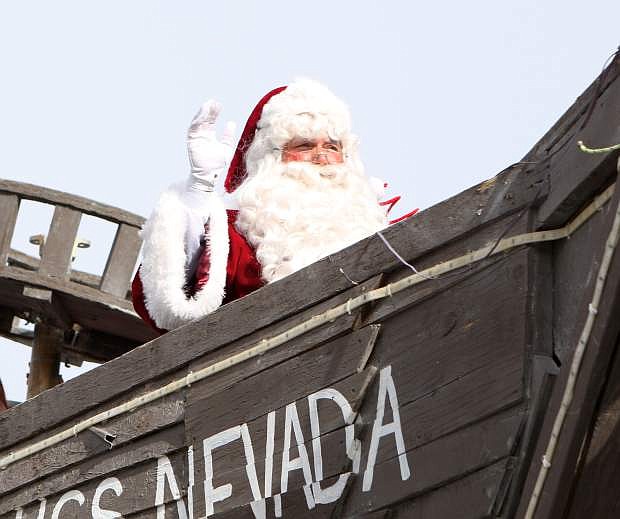 Santa Claus waves to the crowd while he rides the Burning Man art-car &#039;USS Nevada&#039; last year during the Old Time Santa parade in Carson.