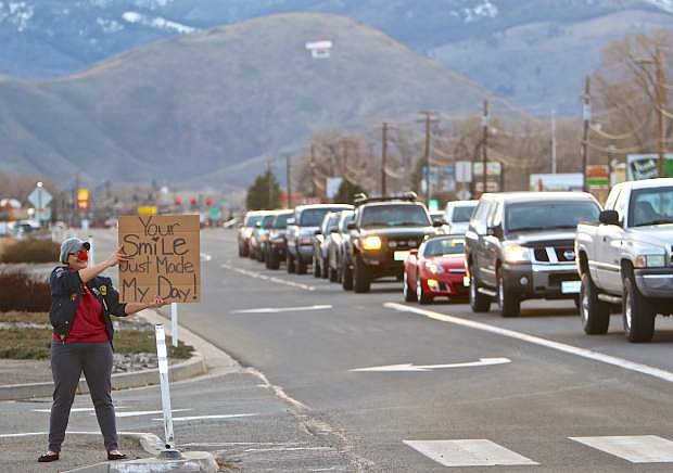 E.D. Crouser of Carson City flashes a homemade sign at drivers as they drive by the intersection of Highway 50 and Fairview Wednesday evening. When asked what motivates her to do what she&#039;s doing she simply stated &#039;because everybody smiles.&#039;