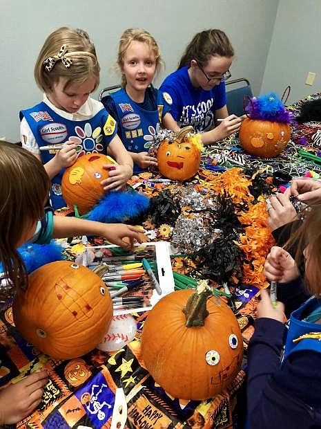 Members of Girl Scouts of The Sierra Nevada Troop 252 decorate pumpkins for seniors who participate in Meals on Wheels Carson City at the Carson City Senior Center.